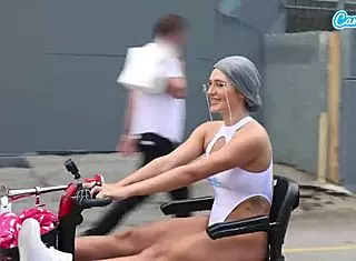 On a public beach sidewalk, a fit MILF granny bends over for doggystyle sex, her tits bouncing wildly.