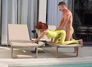 a young cowboy girl saddles a stallion with her friends