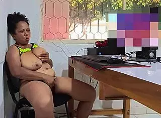 Busty mature woman masturbates in the office during break