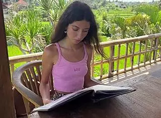 cute girl enjoys burger in public cafe