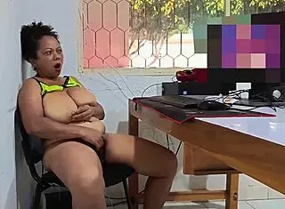 Busty mature woman masturbates in the office during break