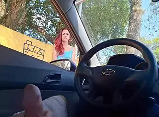Risky public masturbation by a hot redhead in a miniskirt on the street.