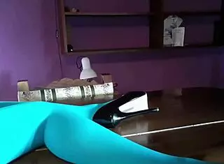 Beautiful Latina MILF shows off her legs in pantyhose and heels on the desk