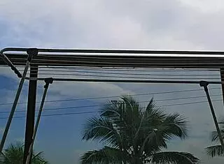 Naughty employee flashes her big ass on the balcony, feeling excited.