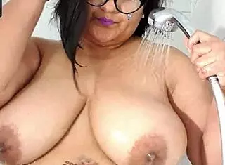 In a live webcam show, a BBW woman bathes in the shower, revealing her huge tits and boobs.