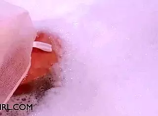 Petite brunette relaxes in bath