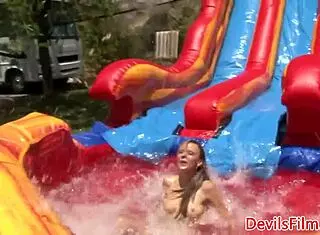 Lesbian beauties toy shaved pussies outdoors with piercing