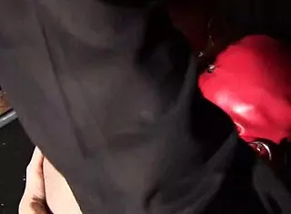 is this red latex girl getting fucked in horror shop threesome?