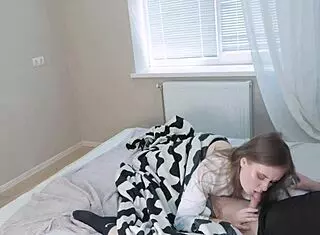 stepdaughter quietly gives oral while stepmom displays her chest in a subtle family moment