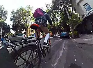 trans in minifalda exhibits upskirt on city streets with pigtails