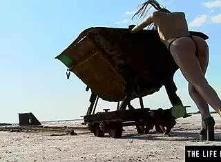 In the vast desert, perfect Hispanic girl with small tits and brunette hair fingers her pussy solo in heels.