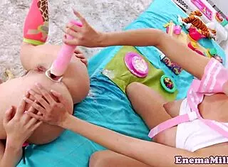 This enema-loving lesbian casually slips a toy into her ass for some messy fun.