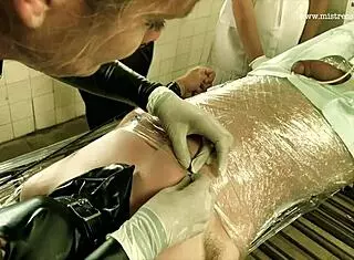 Dominatrix mistress april binds patient in brutal femdom session with cock torment at prison clinic.