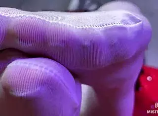 Goddess offers a subtle big booty and foot tease in white stockings on the red couch