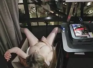 Hey, check out this granny getting naked and masturbating right in front of the city lights at night in a hotel.