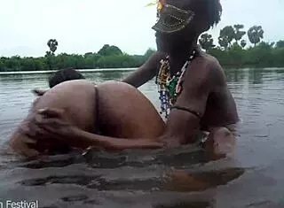 Two tribal lesbians share suggestive river bath