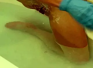 petite girl shaves her pussy lips and clit smooth wearing rubber gloves in bath