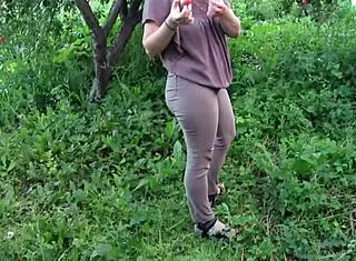 chubby milf soaks jeans with piss in public garden fetish