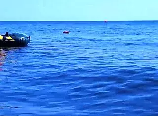 mature bikini babe poses erotically on boat in volga river water