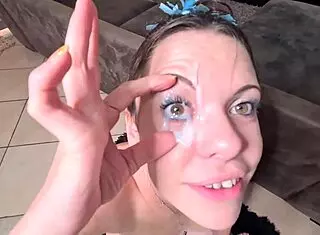 Suggestive cumshot drenches petite whore's eyes after handjob