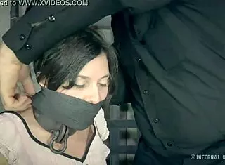 Petite brunette bound in metal bondage for whipping and fingering.