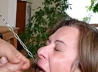 female slave performs blowjob in submission