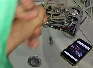 gardener discovers boss's iphone, jerks off in bathroom after finding her xv�deos page while she washes dishes in kitchen