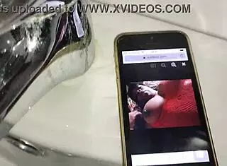 gardener discovers boss's iphone, jerks off in bathroom after finding her xv�deos page while she washes dishes in kitchen