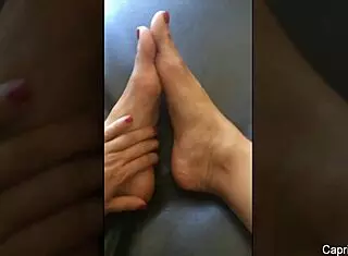 Capri Cavanni's foot fun contrasts with her nude body.