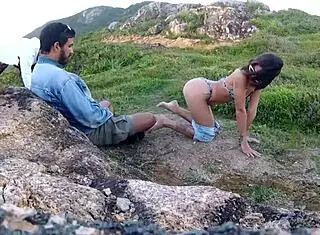 young girl giving blowjob on rocks by the sea