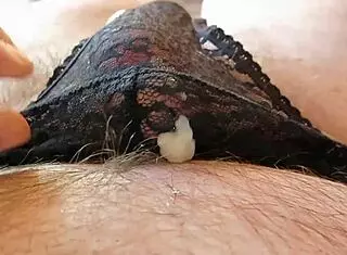 Man shoots cum into black panties in hotel room