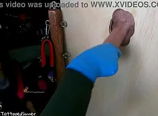 Teen college girl gives handjob through glory hole