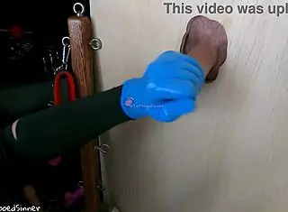 Teen college girl gives handjob through glory hole