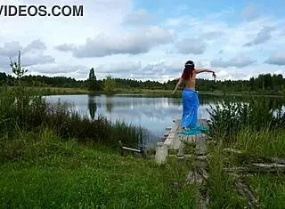 Mature lady poses in bikini on lake