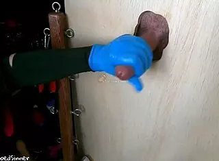 Teen college girl gives handjob through glory hole