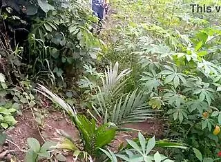 King's ebony maid gets fucked by two guys outdoors on the cassava farm
