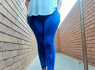 This ebony girl flashes her big natural tits and ass outside