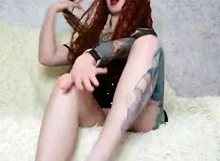Hot tattooed girl in dress and socks performs foot fetish