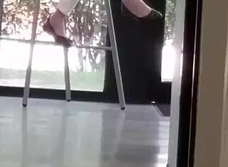 Mature woman playfully engages with shoes