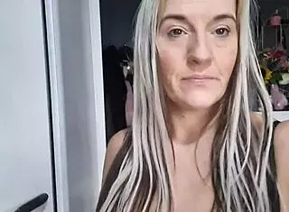 A mom records herself putting on clothes at home in a cute homemade video.