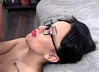 Angelya G sucks and licks balls on big cock, cumshot on face with glasses in close up.