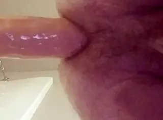 gay guy teasingly tries fitting a large dildo into his ass