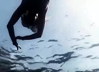 sexy blonde in bikini swimming?