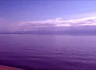 Pretty blonde woman relaxes on the beach with shaved body