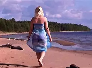 Pretty blonde woman relaxes on the beach with shaved body