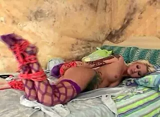 Busty blonde gets bound and photographed by her handsome boyfriend using toys.