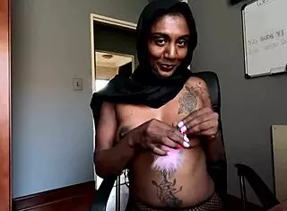 Desi Hijab Girl Smokes with Nipple Clamps On. Solo Indian Beauty in Fishnets Shows Pierced Nipples.