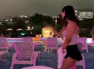 Japanese babe rides in night pool with big tits