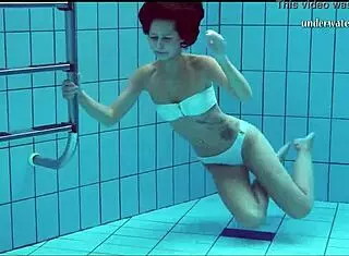 Hot European babe shows tits and shaved pussy underwater