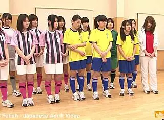 japanese female team listens and takes a lesson from their coach. cute brunette babe in costumes follows instructions closely